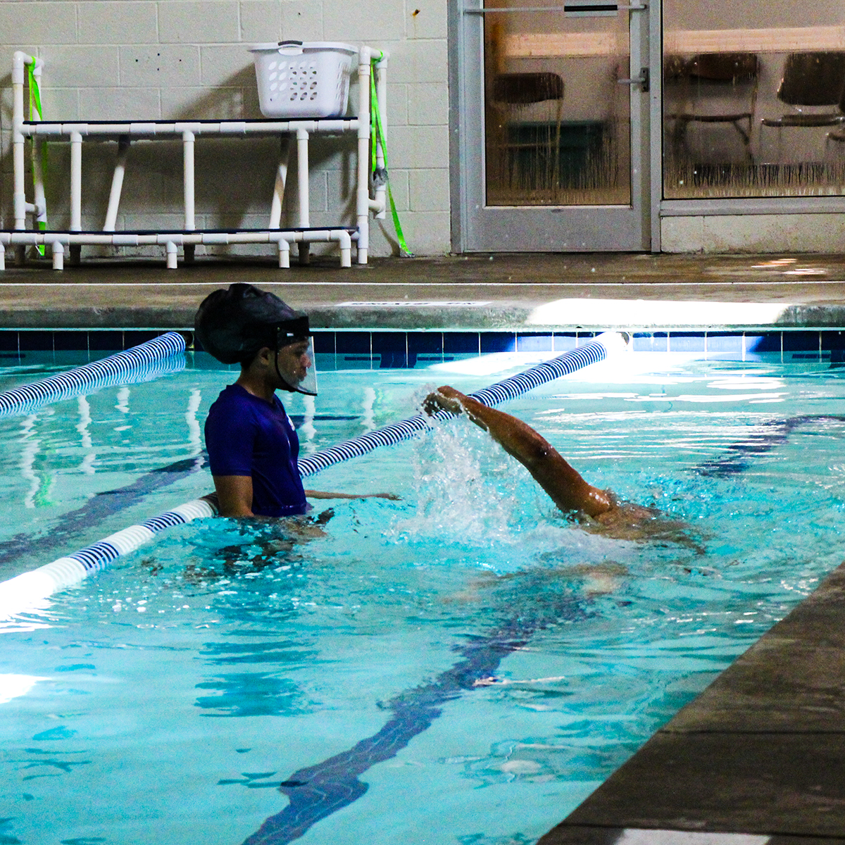 Student demonstrating freestyle stroke for instructor 